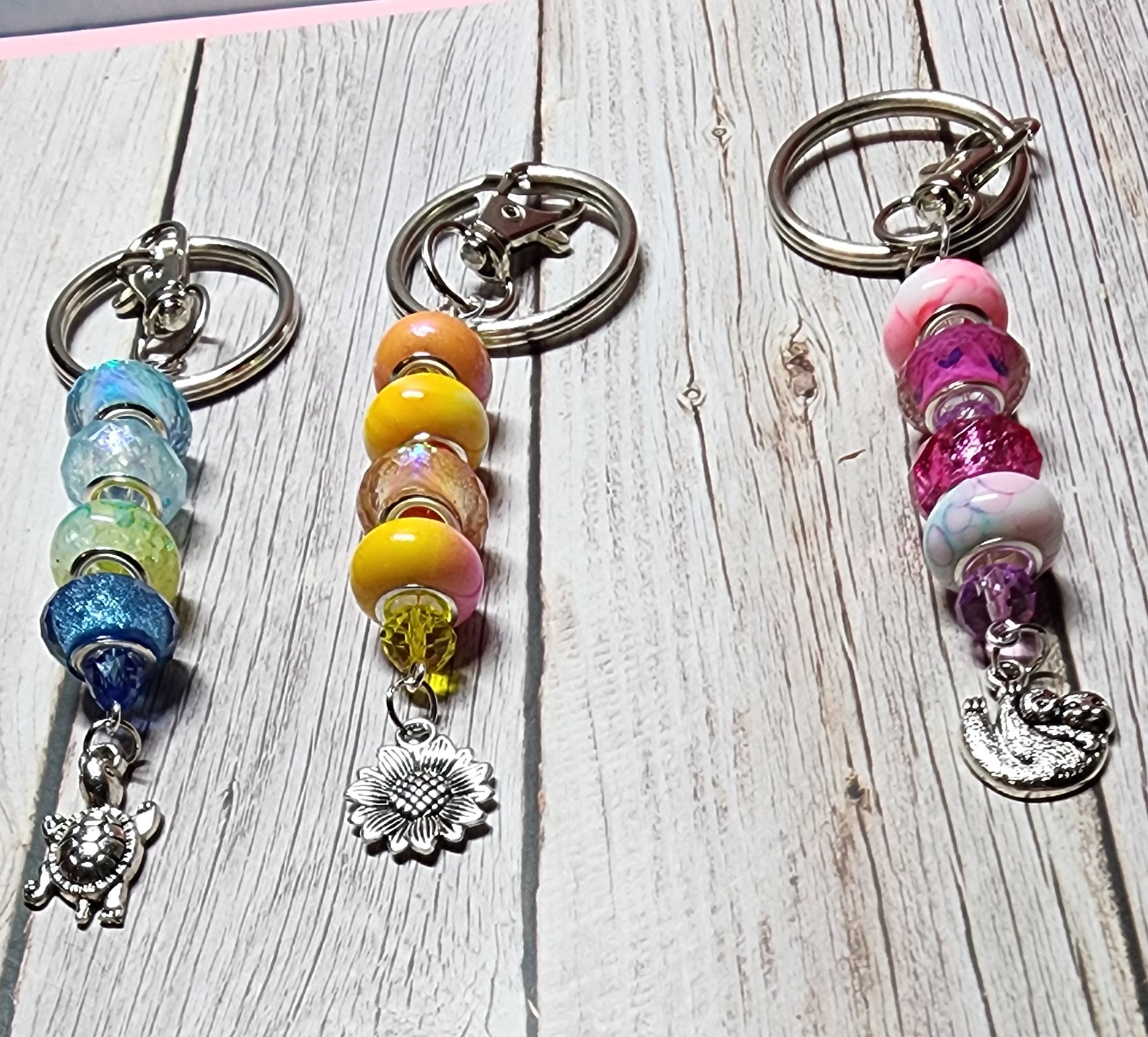 European glass beaded keychain, angel wings, sloth, turtle, sunflower charms, inspiration charm.