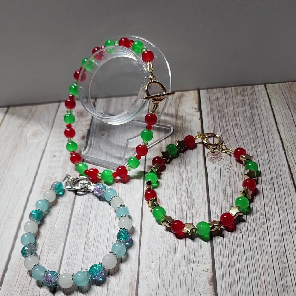 Elegant red and green glass bead Christmas bracelets with dazzling gold accents andspacer beads