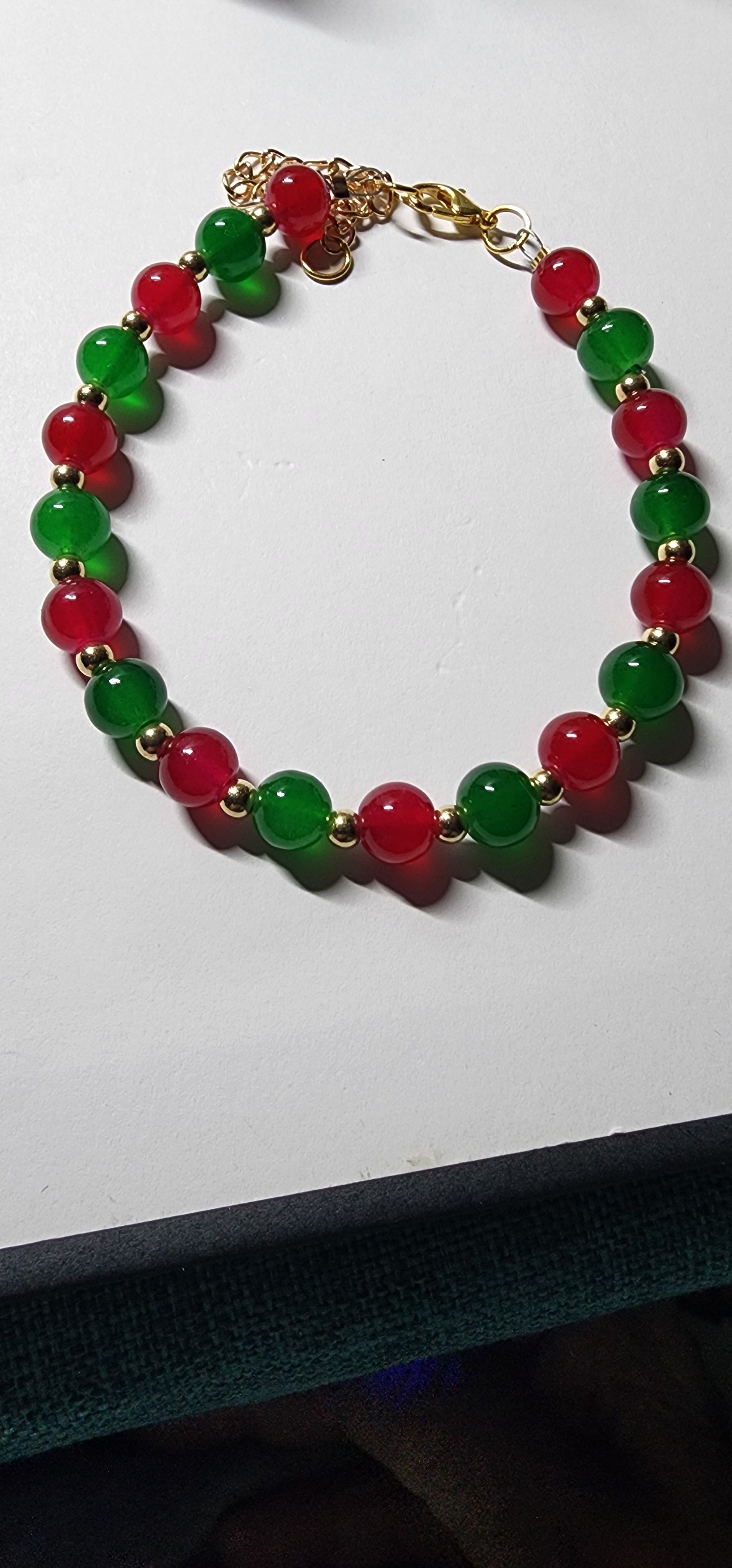 Elegant red and green glass bead Christmas bracelets with dazzling gold accents and spacer beads.  Christmas gift,  festive holiday jewelry.