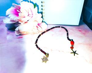 Red glass beaded bookmark with ocean themed gold tone charms