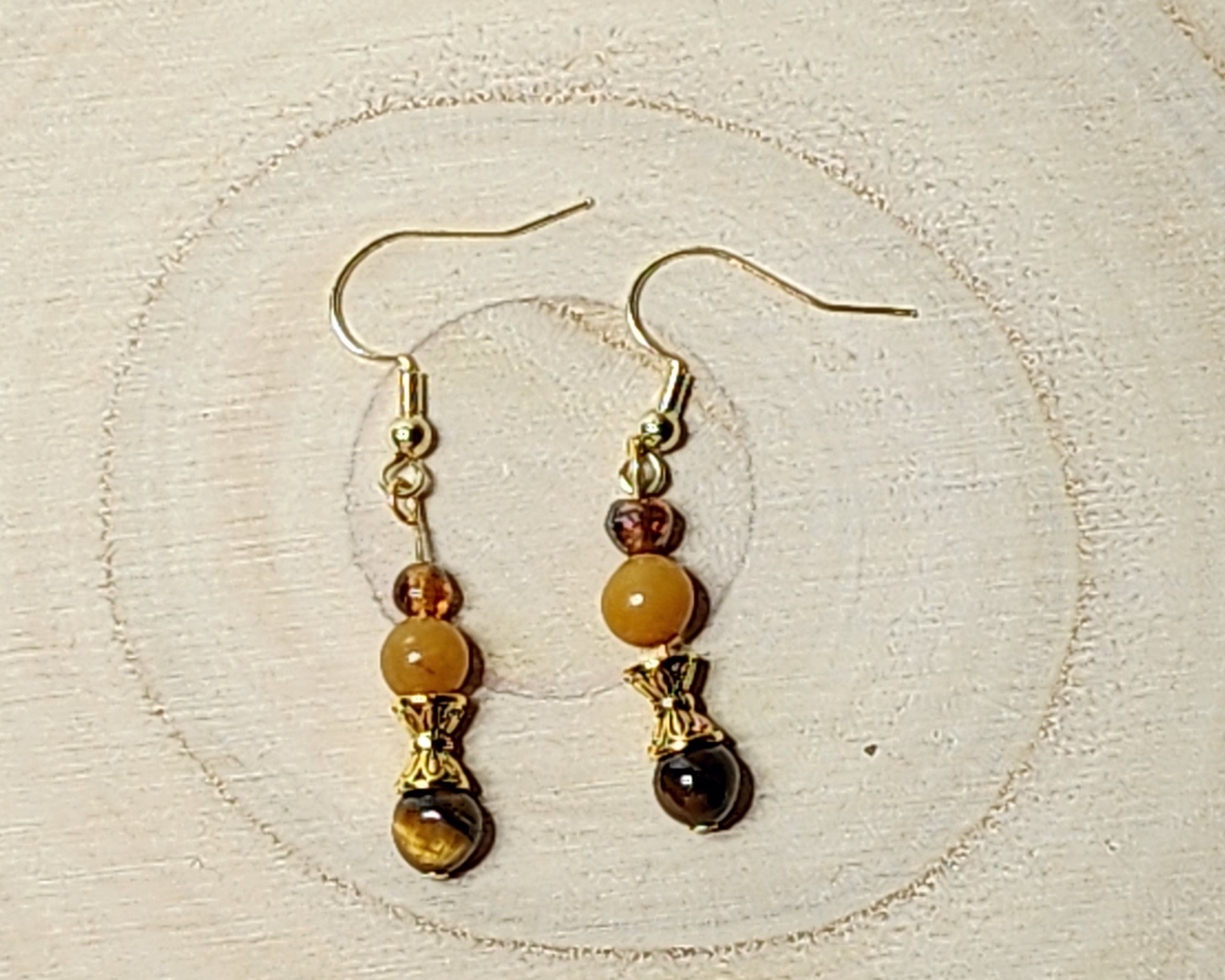 Dainty gemstone dangle earrings with dual sided gold tone bead caps