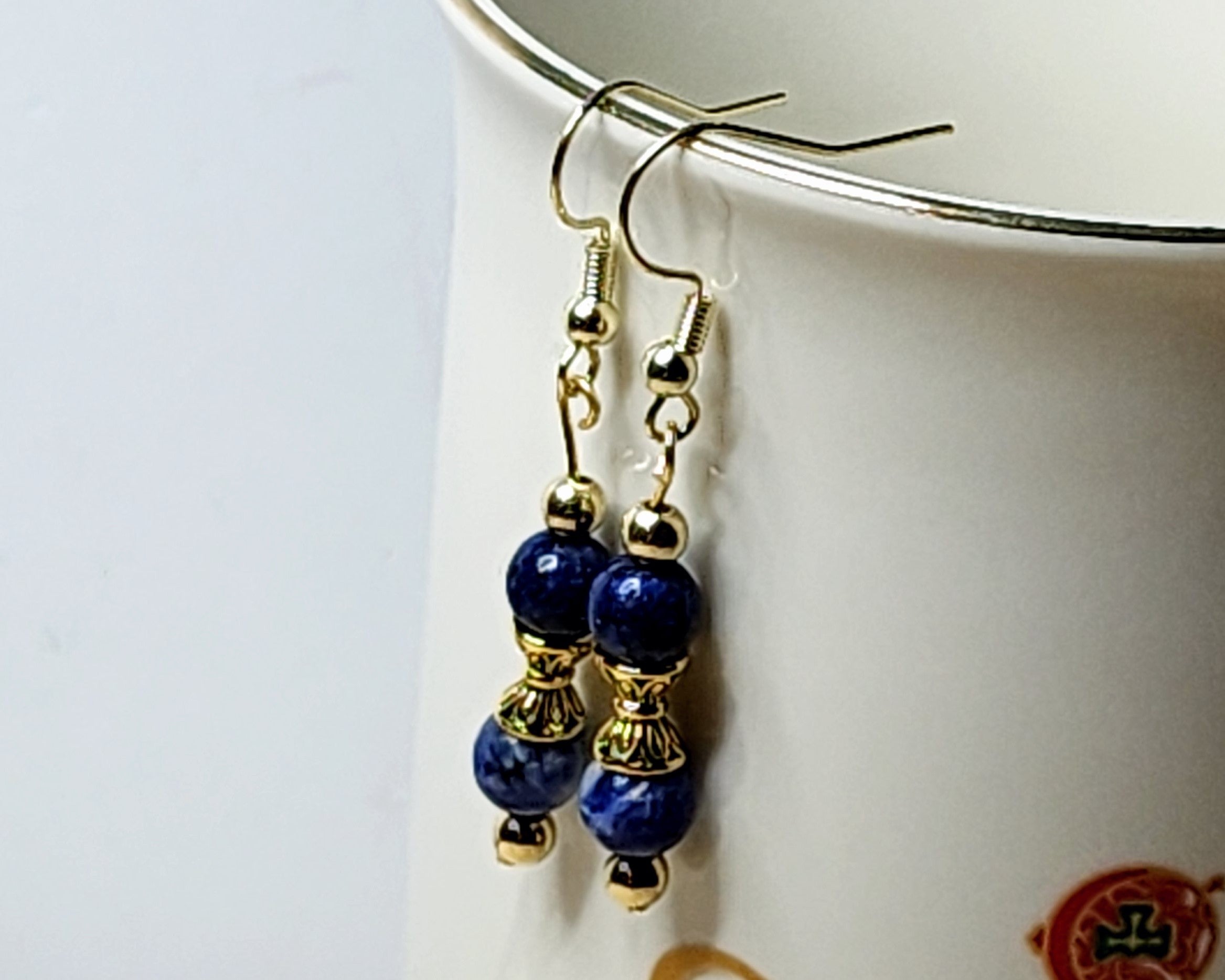 Dainty gemstone dangle earrings with dual sided gold tone bead caps