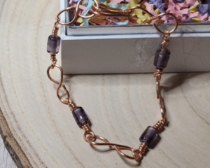 Handcrafted Copper Infinity Bracelet with Purple Beads – Unique Artisan Jewelry