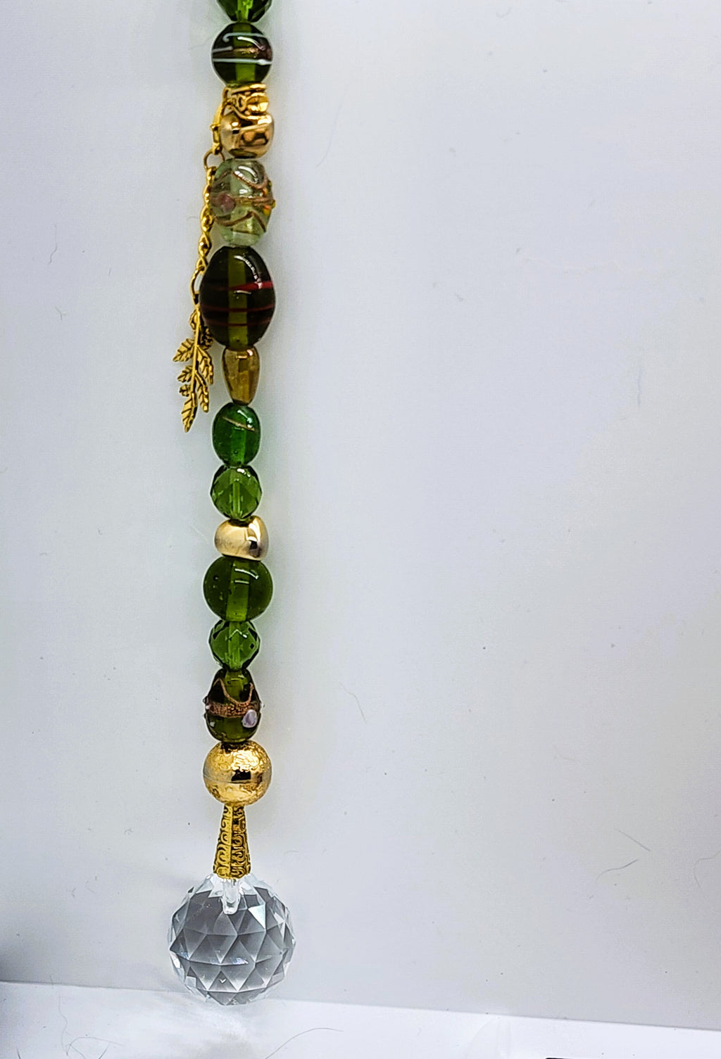 Handmade Green Glass Suncatcher with 30mm Crystal Prism and gold-colored accents