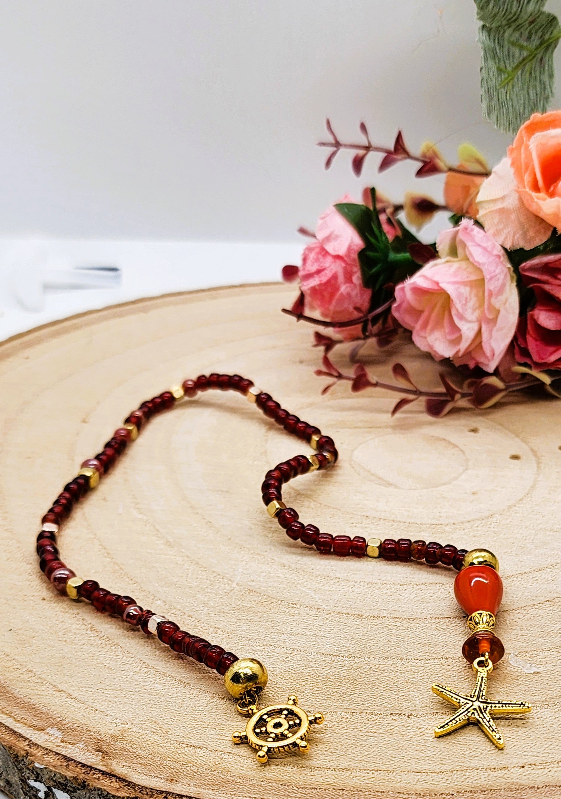Red glass beaded bookmark with ocean themed gold tone charms