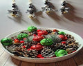 Wooden Christmas ornaments with gold and silver bells. Black and white with animal themed beads on a buffalo checked ribbon.