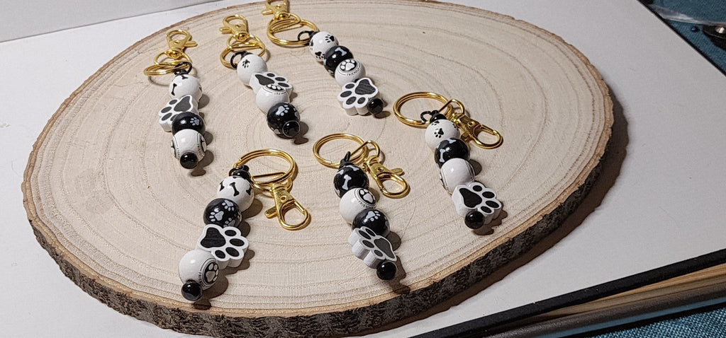 Handcrafted Wooden Pawprint Keychains in gold or silver color