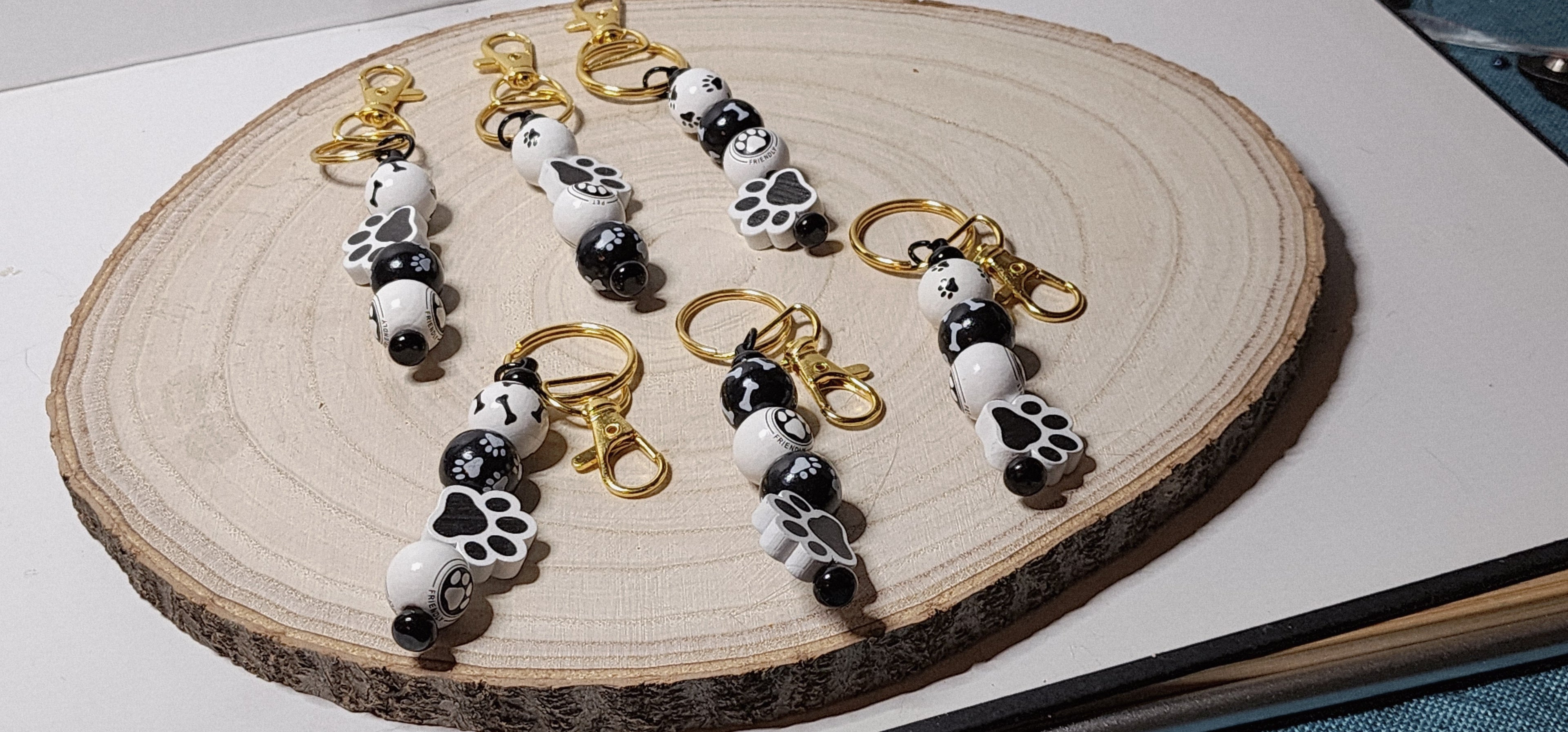 Handcrafted Wooden Pawprint Keychains in gold or silver color