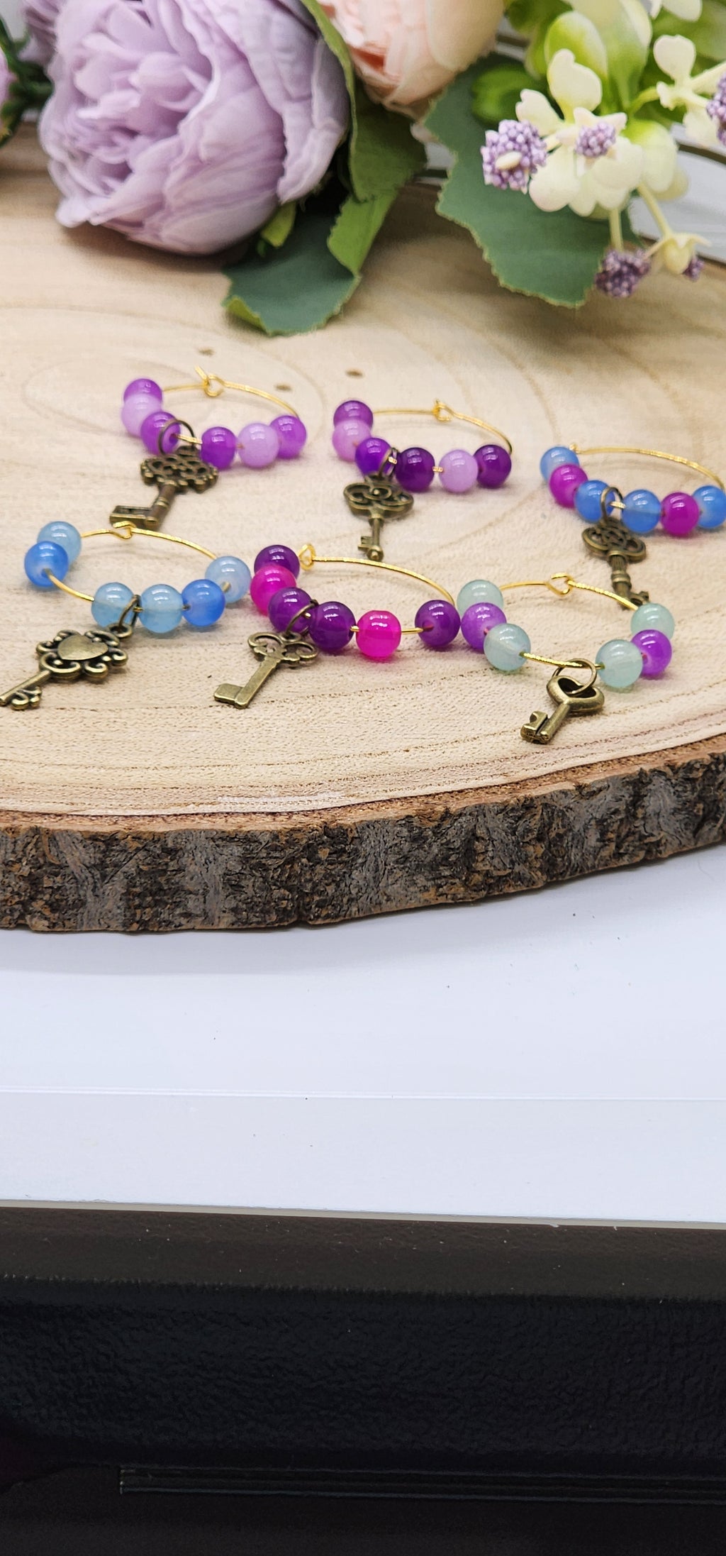 Wine glass markers with glass and gemstone beads and various themes of charms